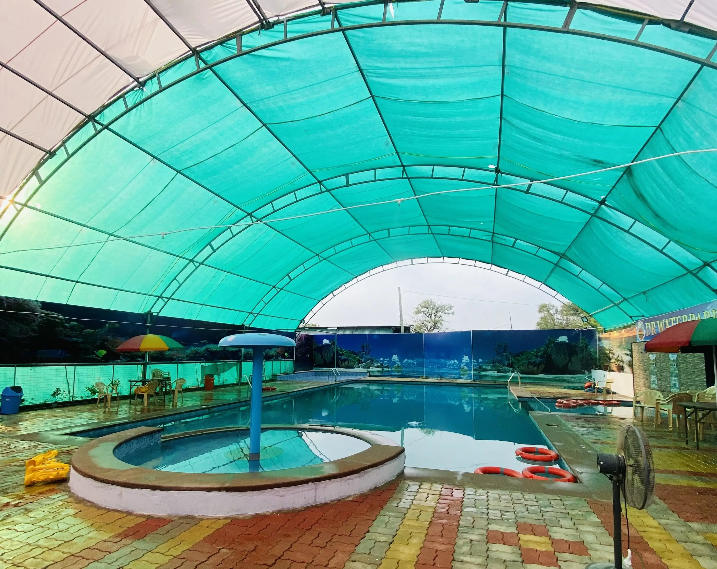 Happy family enjoying the main swimming pool at DR Waterpark